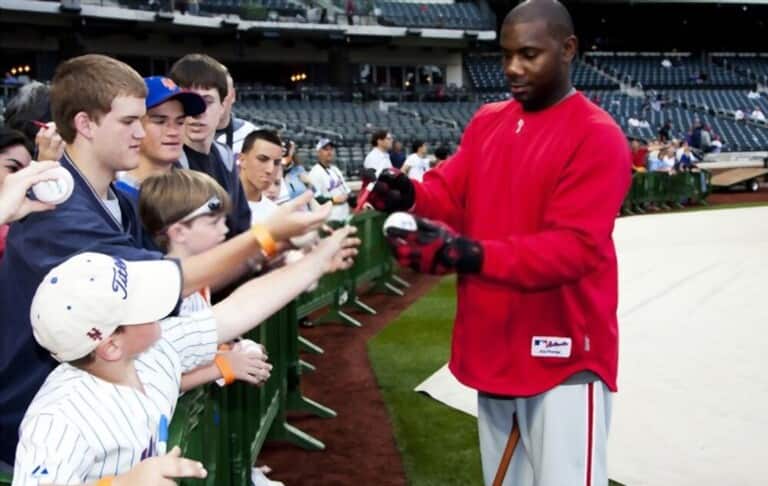 Fans excitedly waiting for the baseball player to sign autographs Fans excitedly waiting for the baseball player to sign autographs