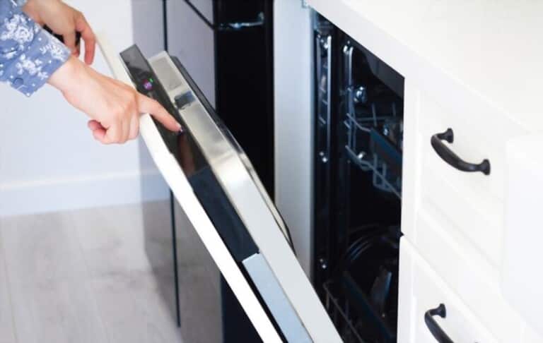 female hand control dishwasher in the kitchen female hand control dishwasher in the kitchen