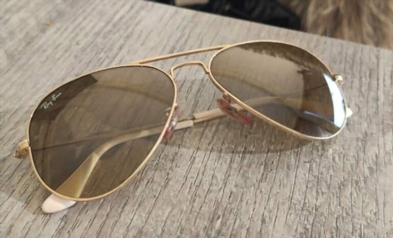 a pairs of aviator sunglasses on wooden table a pairs of aviator sunglasses on wooden table