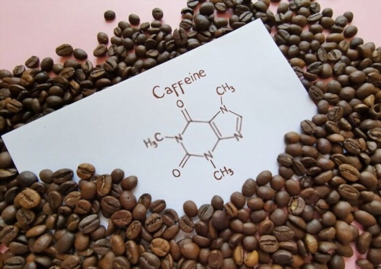 Structural chemical formula of caffeine molecule with roasted coffee beans. Caffeine is a central nervous system stimulant, psychoactive drug molecul