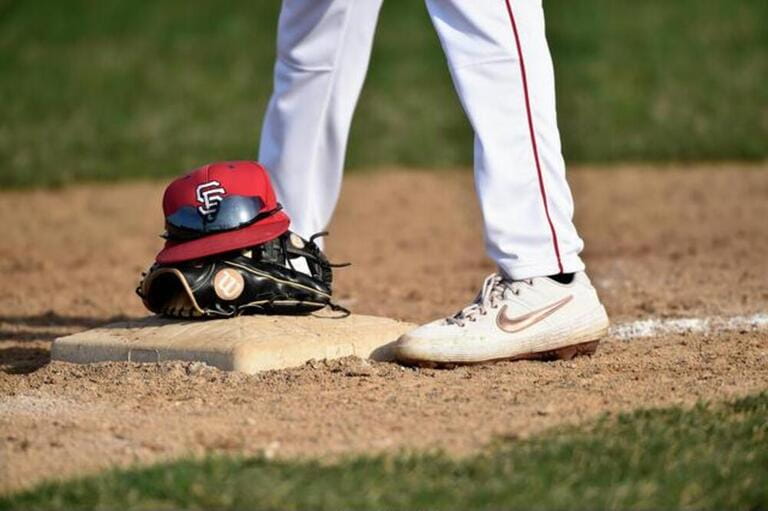 A baseball tradition: A teammate brings out a player's hat, glove and sunglasses and places them on third base. A baseball tradition: A teammate brings out a player's hat, glove and sunglasses and places them on third base.