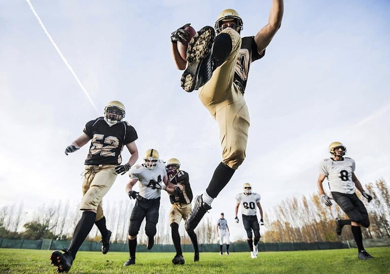 The football team is playing against each other on the field