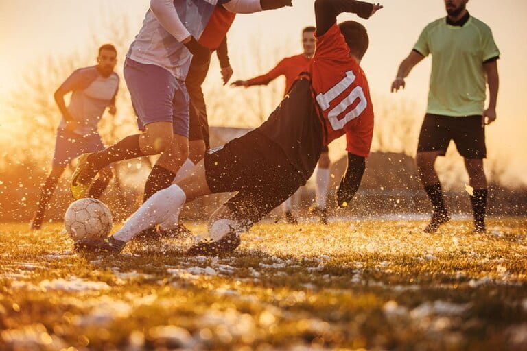 image of enthusiastic men's soccer team at sunset image of enthusiastic men's soccer team at sunset