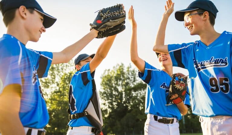 Group of baseball players standing together on the playing field Group of baseball players standing together on the playing field