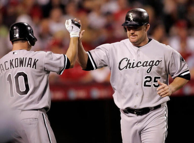 Chicago White Sox's Jim Thome, right, is greeted by teammate Rob Mackowiak at home plate after scoring on a double hit by A.J. Pierzynski against the Los Angles Angels in the fifth inning of a baseball game in Anaheim, Calif
