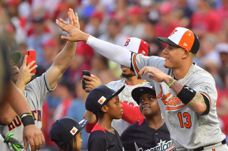 Baltimore Orioles shortstop Manny Machado (13) greets American League teammates during MLB's All-Star Game at Nationals Park in Washington, D.C., July 17, 2018. With trade talk rumors, Machado might be spending his last night in an Orioles uniform, according news reports.