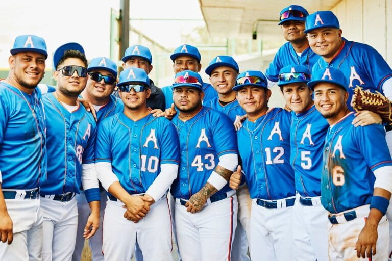 Medium wide shot portrait of professional baseball team in dugout