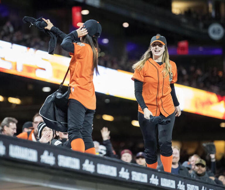 T-shirt girls throw shirts to the fans during a MLB baseball game between the Los Angeles Dodgers and the San Francisco Giants at AT&T Park in San Francisco, California.
