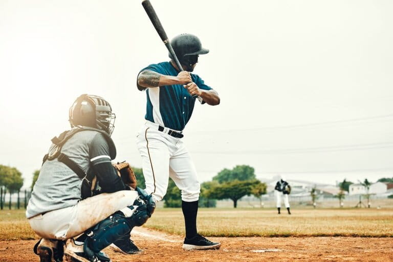 Baseball man, team training game and baseball player baseball bat to hit softball on the field. Professional US athletes, focused and motivated on the sports field Baseball man, team training game and baseball player baseball bat to hit softball on the field. Professional US athletes, focused and motivated on the sports field