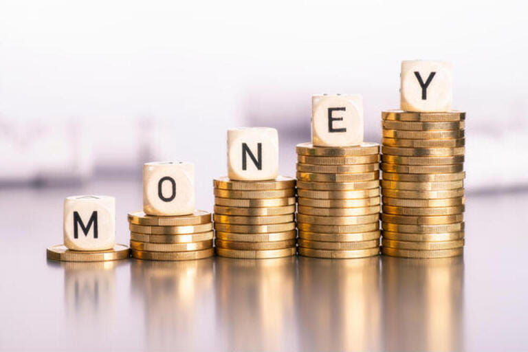 Rising stacks of coins with the word money Rising stacks of coins with the word money