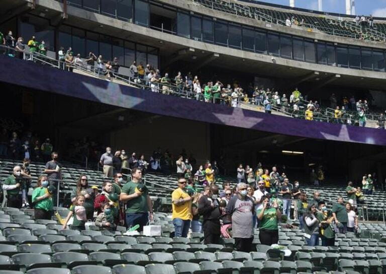 Oakland A's fans stand for the national anthem before the A's take on the Houston Astros at the Oakland Coliseum in Oakland, California Oakland A's fans stand for the national anthem before the A's take on the Houston Astros at the Oakland Coliseum in Oakland, California