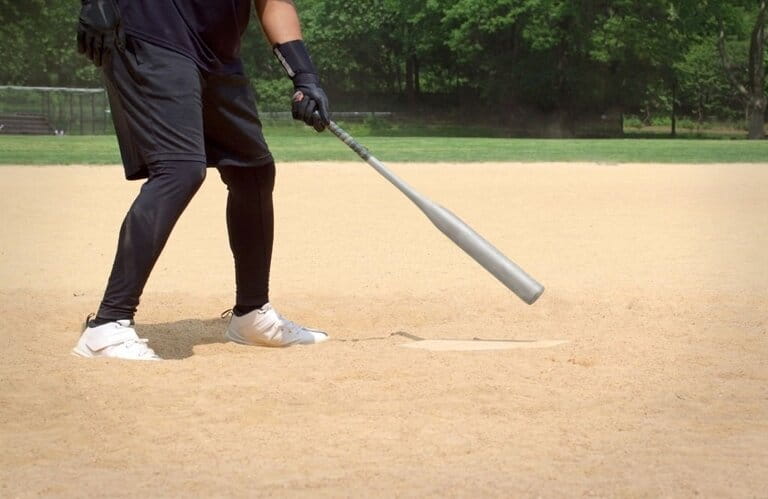 Batter stood holding a baseball bat in his home field at a neighborhood game in the summer Batter stood holding a baseball bat in his home field at a neighborhood game in the summer