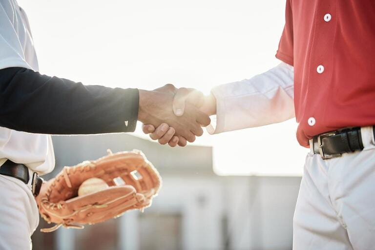 Baseball, sports or handshake for team greeting, introduction or respect on stadium field together. Zoom of men shaking hands in softball match or game in competition, training or workout exercise