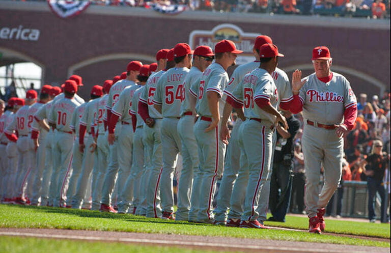 San Francisco, CA, USA; Philadelphia Phillies manager Charlie Manuel (far right) high-fives his team during introductions before game three of the 2010 NLCS against the San Francisco Giants at AT&T Park.