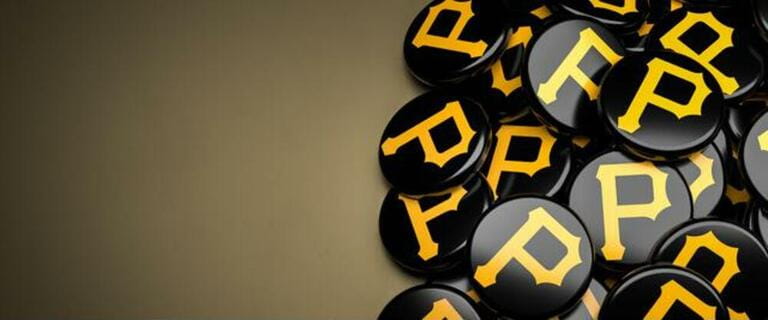 Logos of the American Major League Baseball Team Pittsburgh Pirates on a heap on a table. Logos of the American Major League Baseball Team Pittsburgh Pirates on a heap on a table.