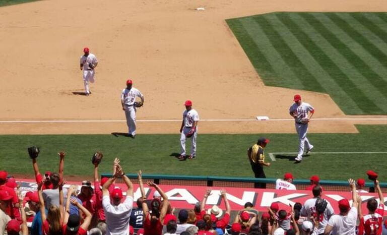Los Angeles Angels baseball players receive cheers from their fans as they head to the dugout, Angel Stadium of Anaheim in California, United States