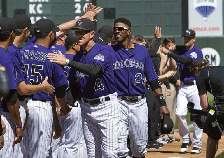 Colorado Rockies manager Jim Tracy and outfielder Dexter Fowler (24) enjoy high fiving teammates during team introductions at Coors Field on Opening Day in Denver on April 1, 2011.  Colorado Rockies manager Jim Tracy and outfielder Dexter Fowler (24) enjoy high fiving teammates during team introductions at Coors Field on Opening Day in Denver on April 1, 2011.