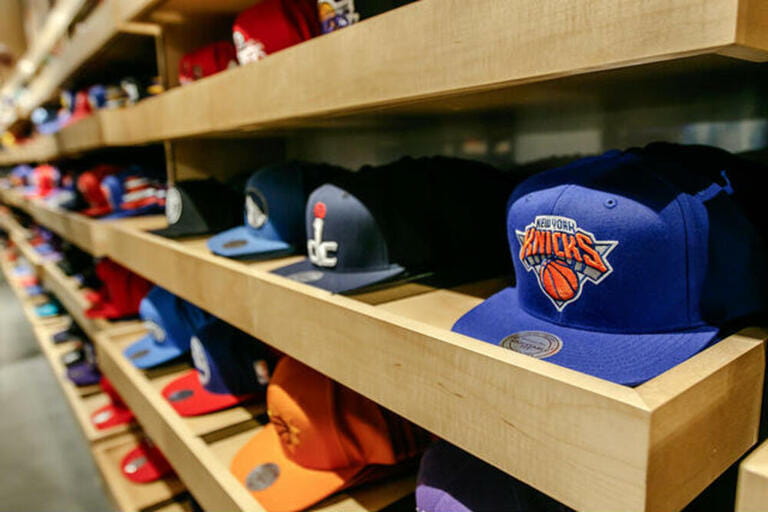 A wide variety of baseball caps with NBA team logos fill the shelves of the NBA store in Manhattan.